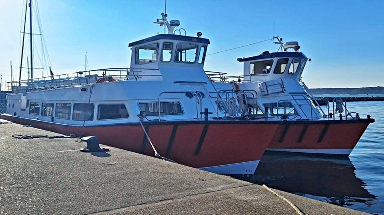 Two orange and white Greenslade ferries moored at Poole Quay.